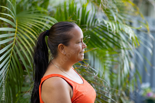 woman in profile with dark hair in high ponytail photo