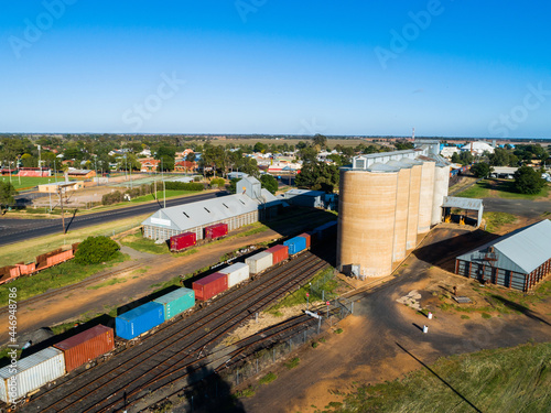 Aussie country town scene in Narromine of grain silos beside railway and freight train photo