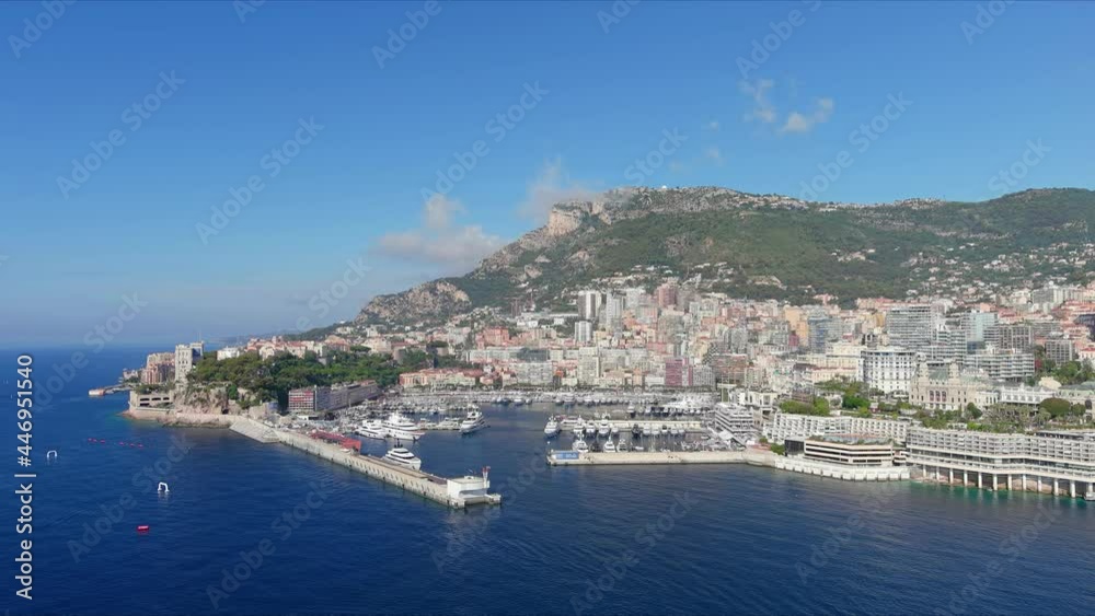 Monte Carlo, Monaco. Aerial view of famous city towering over Mediterranean Sea, Monte Carlo Casino in center of city, marina Port Hercules, clear blue sky - landscape panorama of Europe from above Monte Carlo, Monaco. Aerial view of famous city towering over Mediterranean Sea, Monte Carlo Casino in center of city, marina Port Hercules, clear blue sky - landscape panorama of Europe from above