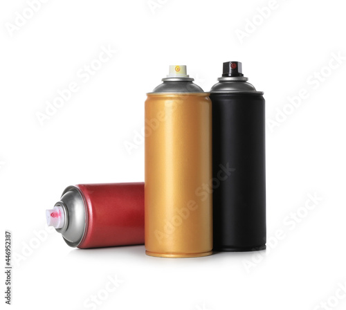 Cans of different spray paints on white background. Graffiti supplies photo