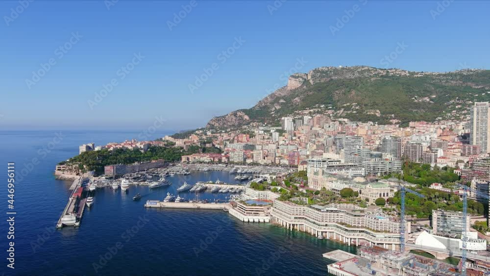 Monte Carlo, Monaco. Aerial view of famous city towering over Mediterranean Sea, Monte Carlo Casino in center of city, marina Port Hercules, clear blue sky - landscape panorama of Europe from above Monte Carlo, Monaco. Aerial view of famous city towering over Mediterranean Sea, Monte Carlo Casino in center of city, marina Port Hercules, clear blue sky - landscape panorama of Europe from above