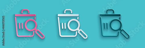 Paper cut Searching for food in trash can on streets outdoors icon isolated on blue background. Homelessness and poverty concept. Paper art style. Vector