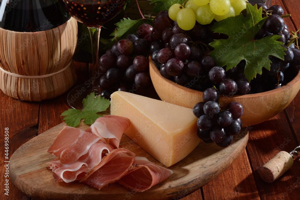 Antipasto with grape, cheese and prosciutto, , selective focus Antipasto with grape, cheese and prosciutto, , selective focus