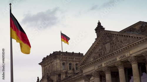 4K video of flags flying outside Reichstag or Deutscher Bundestag German Parliament building in Berlin, Germany