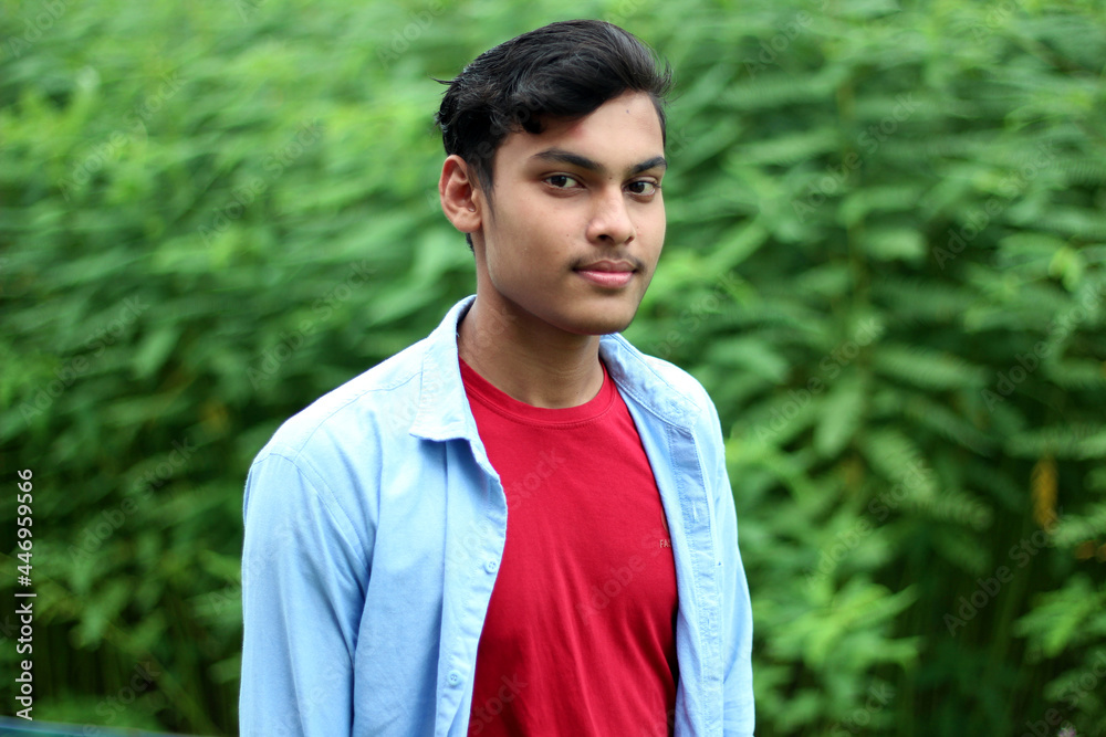 A young man is standing and the background blur A young man is standing and the background blur