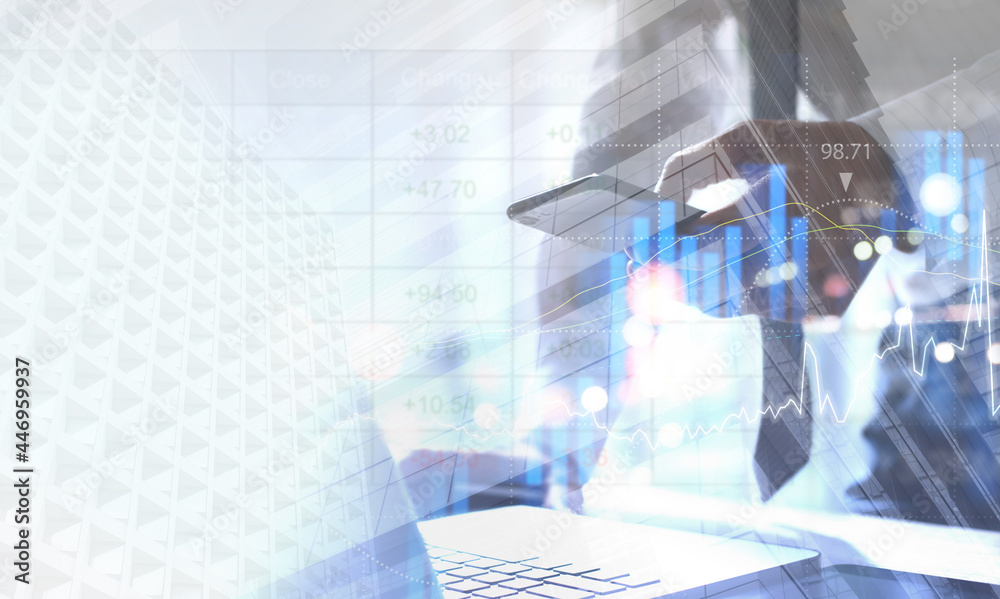 Double exposure of businessman working in modern office and buildings in the city with financial trading graph, market report