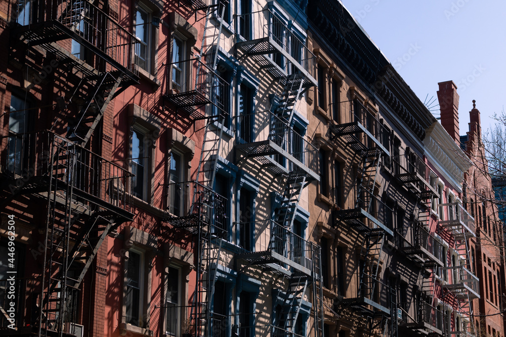 Row of Colorful Old Apartment Buildings with Fire Escapes in Greenwich Village of New York City