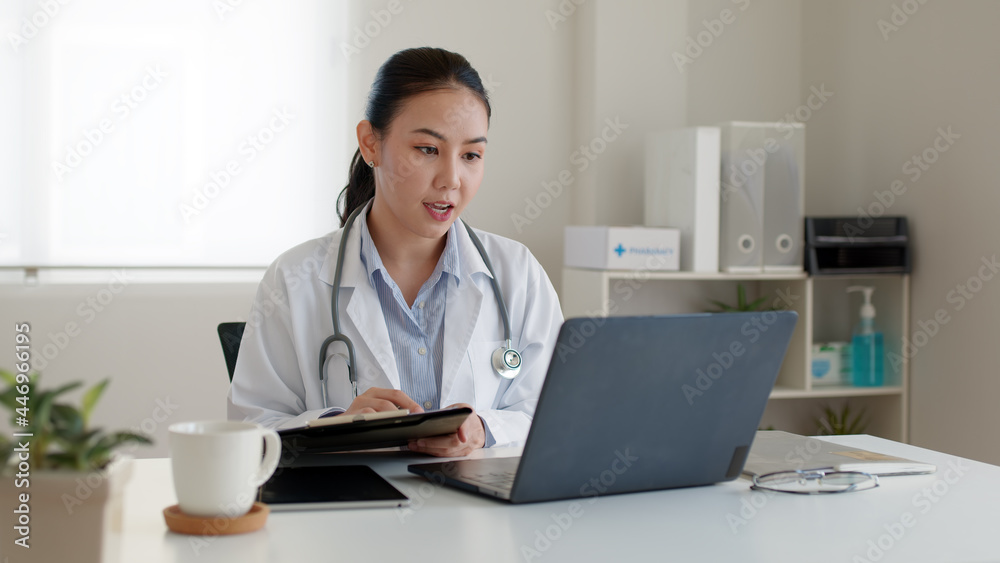 Young asia people or female doctor live talk looking and speaking at laptop computer work in online clinic to help patient on digital telehealth telemedicine smart covid consult VoIP service app. Young asia people or female doctor live talk looking and speaking at laptop computer work in online clinic to help patient on digital telehealth telemedicine smart covid consult VoIP service app.