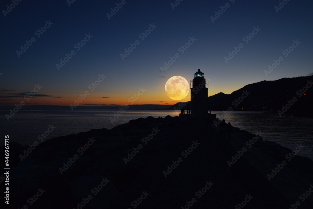 incredible full moon over the sea at the lighthouse of Camogli