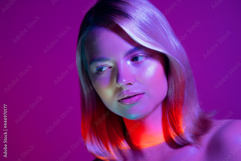 Portrait with neon-style lighting, a young beautiful blonde