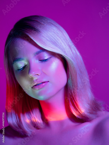 Portrait with neon-style lighting, a young beautiful blonde