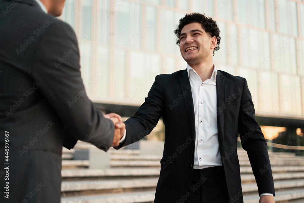 Meeting confident economists discuss further actions on the project. Men go to work as brokers in a new office. Business and youth concept. Meeting confident economists discuss further actions on the project. Men go to work as brokers in a new office. Business and youth concept.