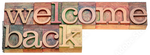 Welcome back banner - isolated text in letterpress wood type, hospitality or business reopening concept photo