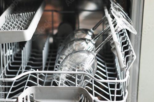 close up photo of raw wine glasses in a dishwasher. Cleaning concept.Selective focus for cleaning Wine glasses in dishwasher machine.