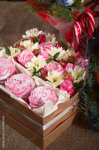 Christmas gift set of pink marshmallows, flowers and candy canes © AlexLit