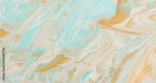 art photography of abstract marbleized effect background. Gold, mint and white creative colors. Beautiful paint.