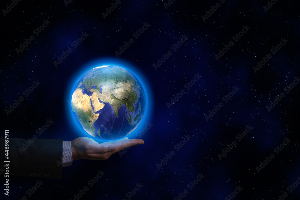 A businessman hand wear suit with earth sphere and map over his hand in the dark background. World global business and environment concept.