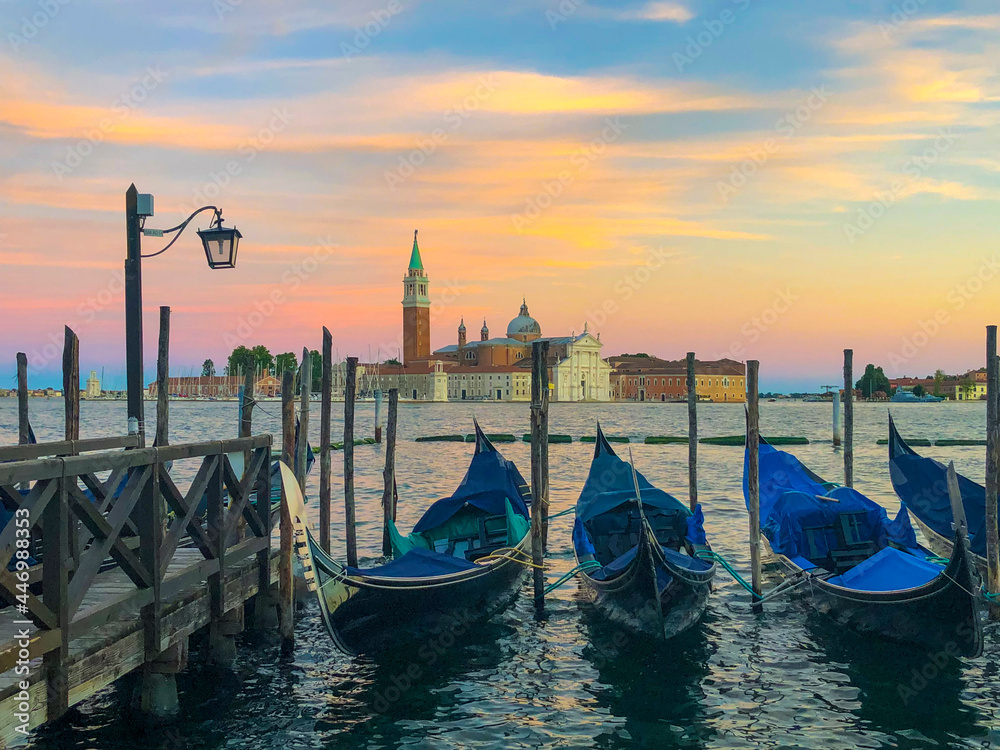blurred gondolas at San Marco with view in early morning to island San Georgio Maggiore in Venice