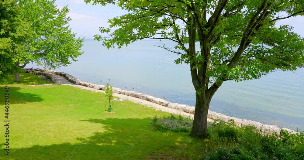 Establishing shot of Lake with White Clouds in Toronto, Canada, North America. Day time on July 2021. Still camera view. ProRes 422 HQ. Establishing shot of Lake with White Clouds in Toronto, Canada, North America. Day time on July 2021. Still camera view. ProRes 422 HQ.