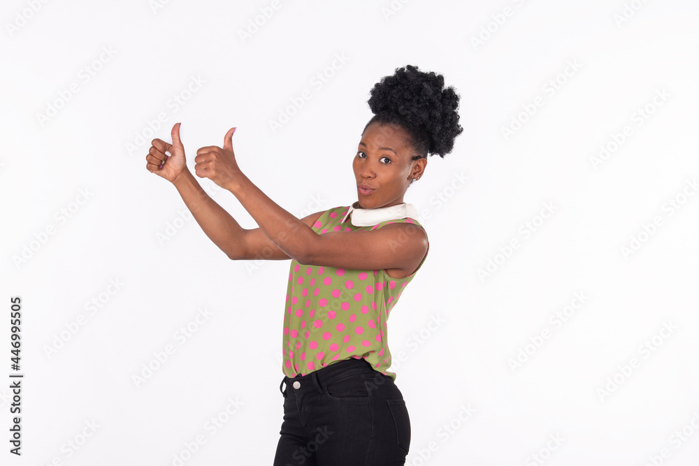 Mischievous latina woman doing a thumbs up gesture with raised hands Mischievous latina woman doing a thumbs up gesture with raised hands