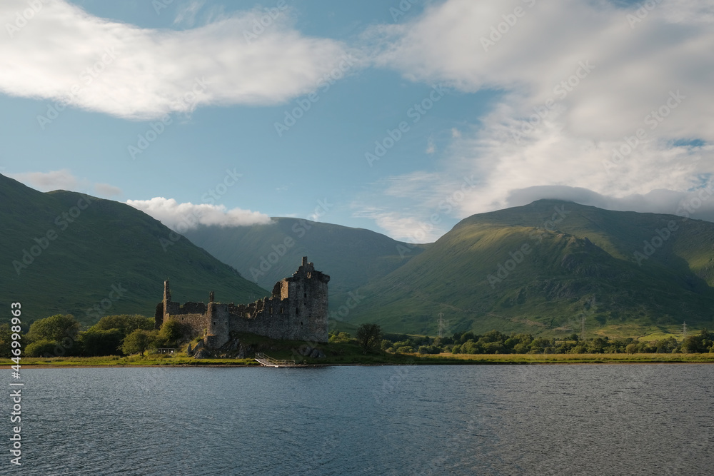 Castle ruins on a lake. Kilchurn Castle on Loch Awe in summer in the Scottish Highlands