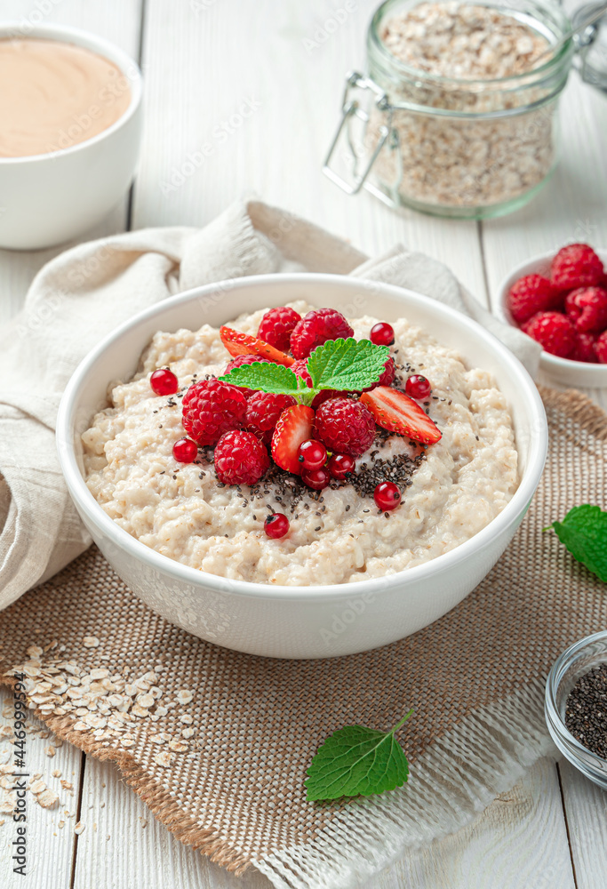 Healthy breakfast, oatmeal with fresh berries on a light background. Side view, close-up. Vegetarian, dietary food. Healthy breakfast, oatmeal with fresh berries on a light background. Side view, close-up. Vegetarian, dietary food.