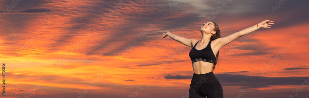 A sporty slim girl in leggings and a top is standing with a training mat, resting between exercises. Fitness and healthy lifestyle. A sporty slim girl in leggings and a top is standing with a training mat, resting between exercises. Fitness and healthy lifestyle.