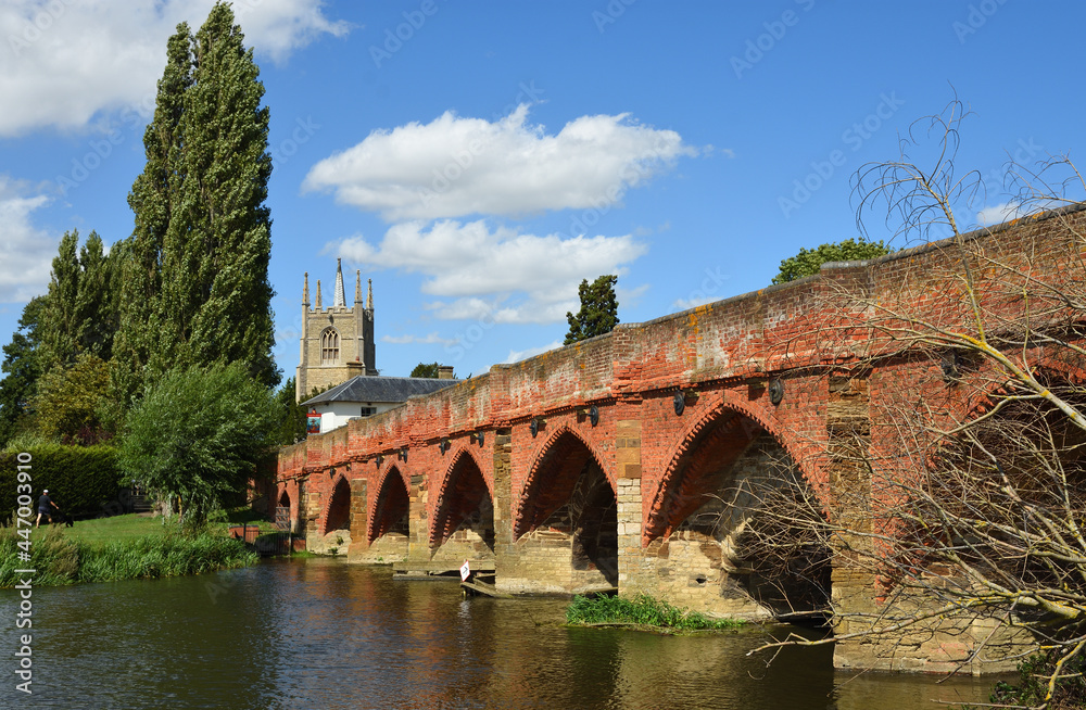 Fototapeta premium Great Barford Packhorse Bridge and Church Bedfordshire England.