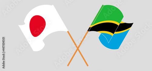 Crossed and waving flags of Japan and Tanzania