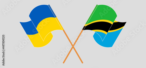 Crossed and waving flags of Ukraine and Tanzania