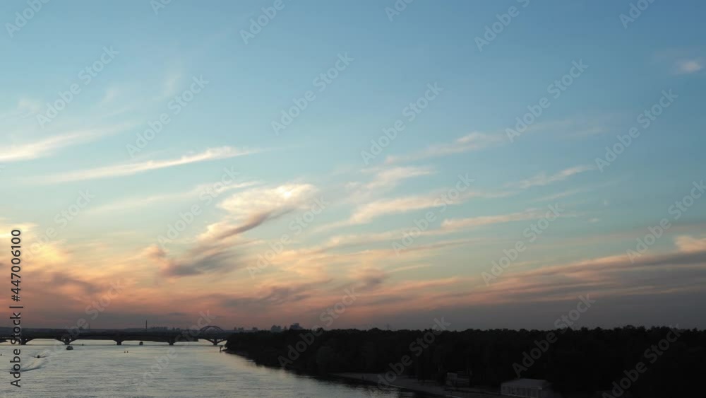 Top Aerial view Colored evening summer sky. sailing motor boat with angler on Dnipro river at sunrise sunset. landscape of bridge over lakes in Kiev Ukraine city. water transport, travel Top Aerial view Colored evening summer sky. sailing motor boat with angler on Dnipro river at sunrise sunset. landscape of bridge over lakes in Kiev Ukraine city. water transport, travel