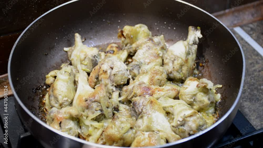 cooking chicken wings in a frying pan, the meat is fried in sunflower oil until golden brown cooking chicken wings in a frying pan, the meat is fried in sunflower oil until golden brown