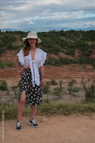 young woman posing in a landscape © Jonathan