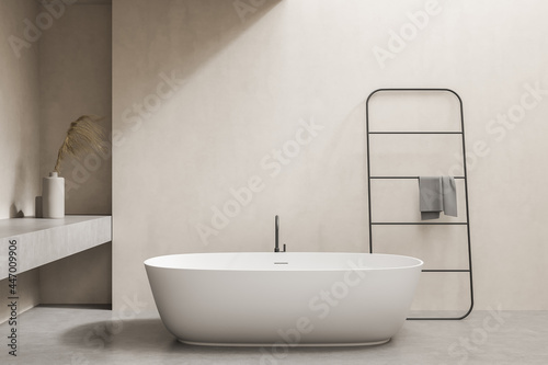 Minimalistic beige bathroom with tub and rail