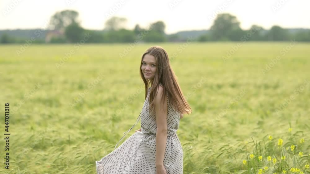 Young beautiful woman in dress having fun in a wheat field. Beautiful carefree woman enjoying nature. Slow motion. Freedom concept. Young beautiful woman in dress having fun in a wheat field. Beautiful carefree woman enjoying nature. Slow motion. Freedom concept.