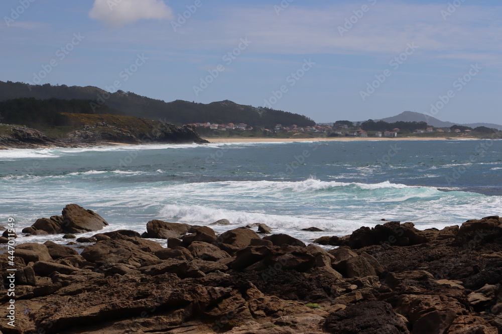 Galician coast with the image of a village in the background, in the castros de Baroña, Galicia, Spain.