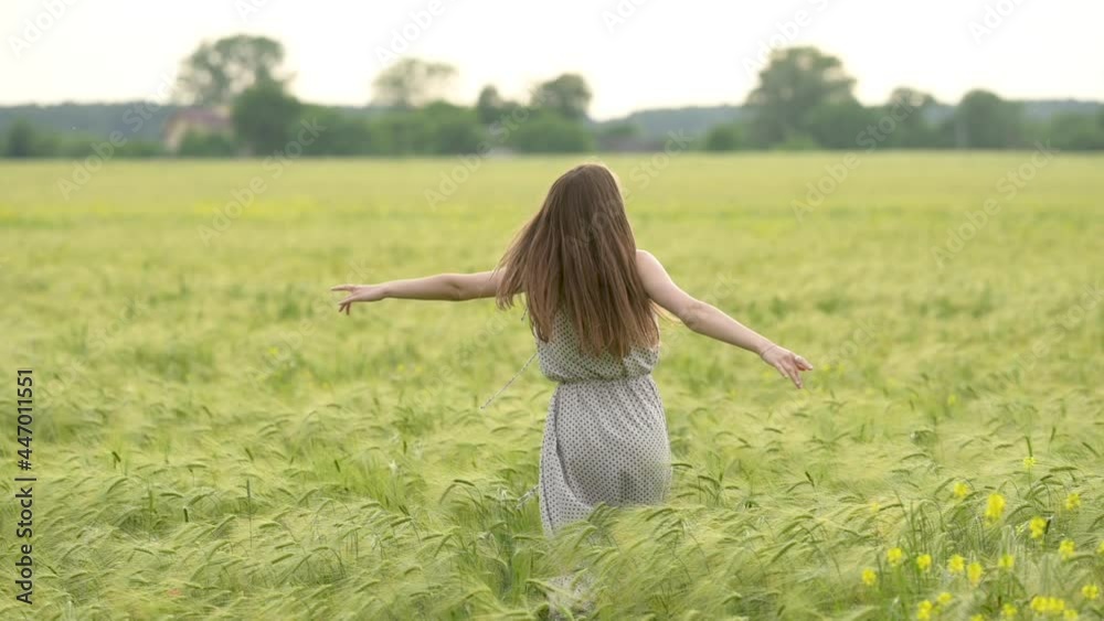 Young beautiful woman in dress having fun in a wheat field. Beautiful carefree woman enjoying nature. Slow motion. Freedom concept. Young beautiful woman in dress having fun in a wheat field. Beautiful carefree woman enjoying nature. Slow motion. Freedom concept.