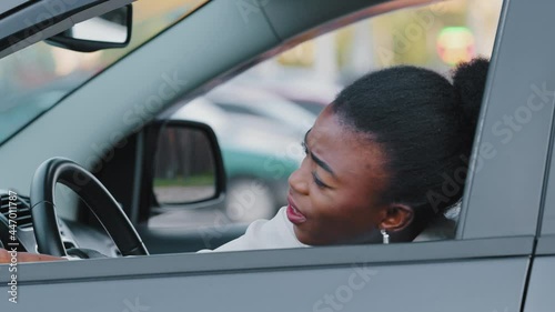 Afro american stressed woman driver african ethnic girl sitting inside luxury car screaming angry waving hands make stop after driving automobile in traffic jam on rush hour, travel and transportation