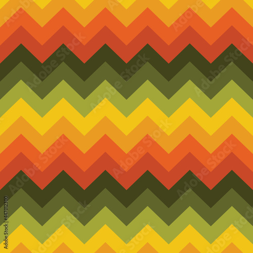1970s retro chevron stripe seamless vector pattern. Funky, groovy, vintage 70's style zigzag background texture in orange, yellow and green earth tones. Bold colourful geometric repeat design.