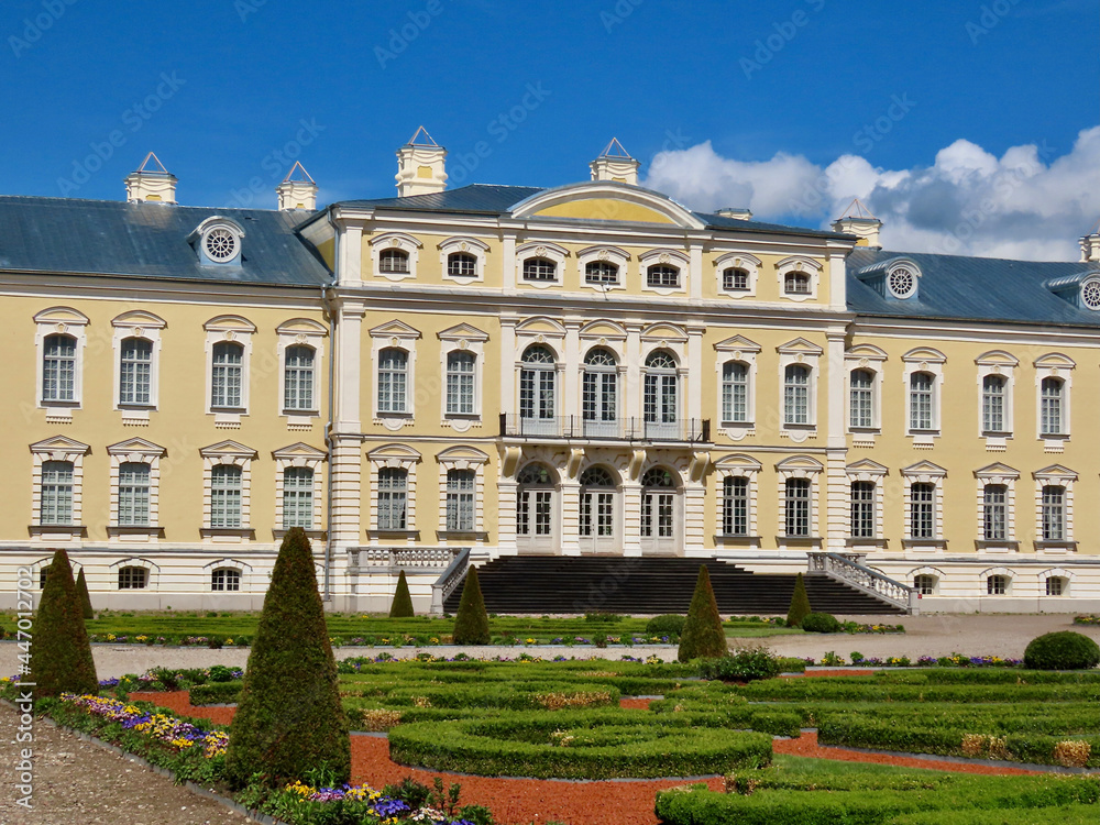 Rundale in Latvia: yellow and white Baroque style palace built for Dukes of Courland by Bartolomeo Rastrelli, view from French gardens, sunny spring day