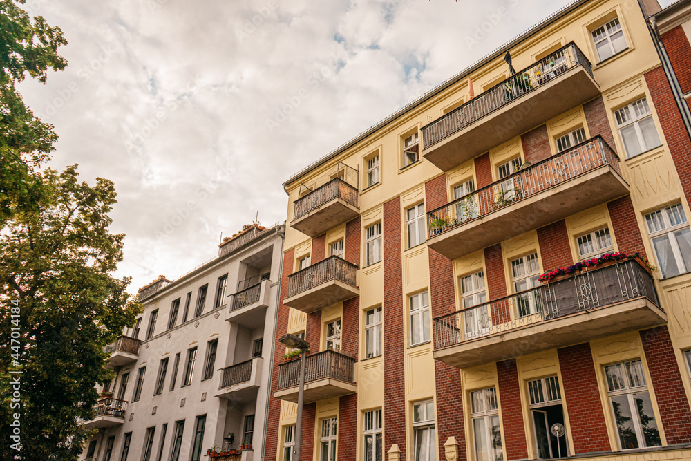 Fototapeta premium two apartment houses with cloudy background