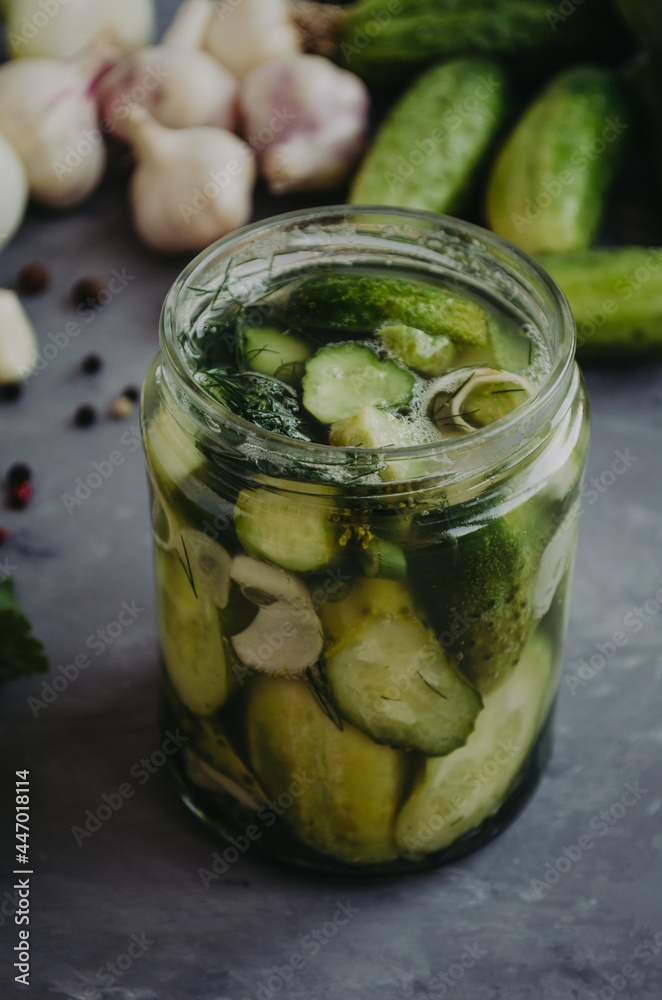 Glass jar with marinated pickled cucumbers in a jar. Selective focus rustic table Glass jar with marinated pickled cucumbers in a jar. Selective focus rustic table