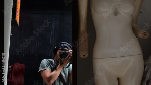 person with camera in front of wall