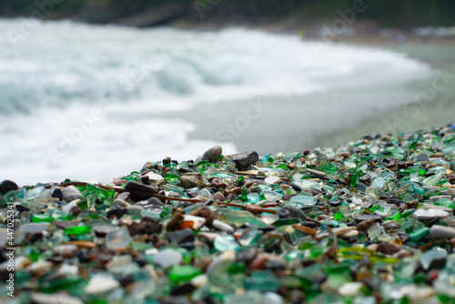 coastal strip of emerald glass pebbles and clear water © Aleksandr