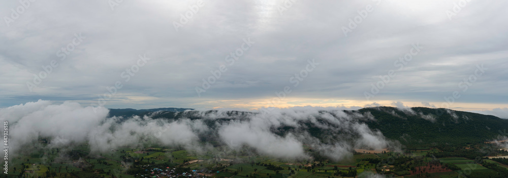 Aerial view Sunrise Beautiful sky with fog clouds. Fantastic foggy landscape glowing while sunrise in the morning. A beautiful landscape with high mountains foggy cover. Dense fog with beautiful light Aerial view Sunrise Beautiful sky with fog clouds. Fantastic foggy landscape glowing while sunrise in the morning. A beautiful landscape with high mountains foggy cover. Dense fog with beautiful light
