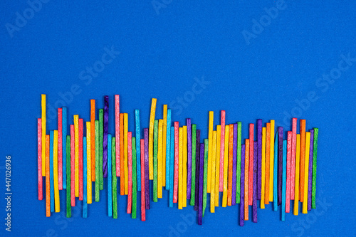 some multicolored sticks on a blue surface 
