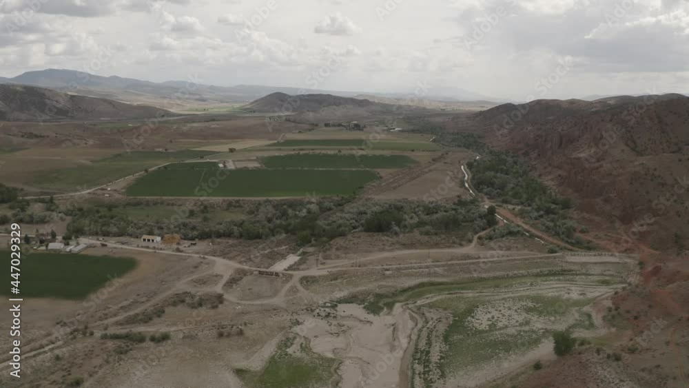 Aerial-Flying over dry empty reservoir toward dam and spillway Aerial-Flying over dry empty reservoir toward dam and spillway