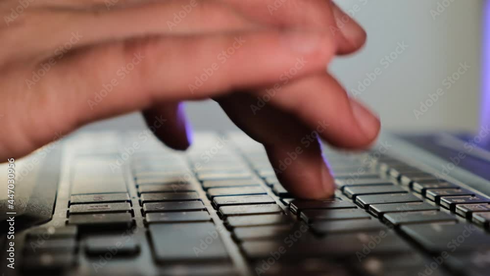 Close up hands typing keyboard.Working or learning from home.Slow motion. Fingers typing on keyboard in purple light. Close up hands typing keyboard.Working or learning from home.Slow motion. Fingers typing on keyboard in purple light.