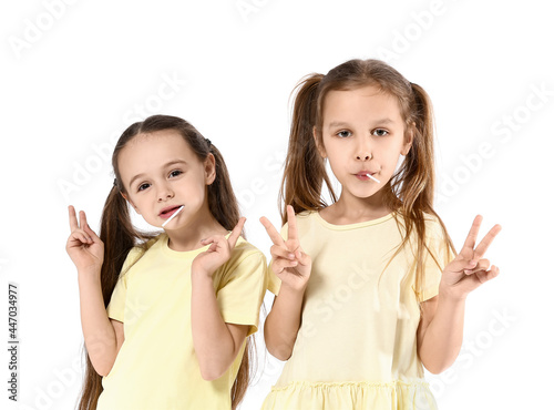 Cute little sisters eating ...