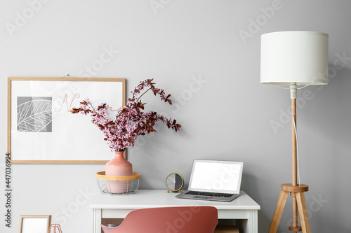 Stylish workplace with vase...